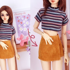 May include: A set of three ceramic mugs with a speckled, cream-colored glaze. Each mug features a different hand-painted floral design in shades of blue, green, and yellow. The mugs have a simple, modern shape.