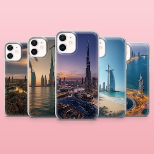 May include: A collection of five clear phone cases, each featuring a different scenic image of Dubai. The images include the Burj Khalifa, the Burj Al Arab, and cityscapes at sunset and night. The cases are designed to fit a smartphone.