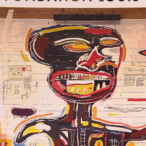 May include: A colorful painting featuring a figure with a black head and body, red mouth, and yellow teeth. The artwork has a graffiti-like style with text and symbols on a white background. The word "FONDATION" is at the top.