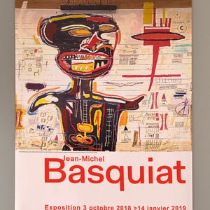 May include: Poster for the Jean-Michel Basquiat exhibition at the Fondation Louis Vuitton. The artwork features a colorful, expressive figure with a large mouth and bold lines. The poster includes the exhibition dates and the names of the artists.
