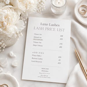May include: A price list for Luxe Lashes, detailing lash treatments and prices in British pounds. The image is styled with white flowers, a lit candle, a gold pen, and a white satin cloth.