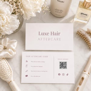 May include: A flat lay arrangement of hair care items. The image shows a conditioner bottle, perfume, a hairbrush, a hair clip, and a silk scrunchie. Two cards display "Luxe Hair Aftercare" and "Hair Aftercare Guide".