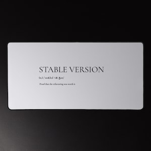Puede incluir: Una tarjeta rectangular blanca con el texto "STABLE VERSION" en fuente serif. Debajo, la pronunciación fonética y la frase "Proof that the refactoring was worth it."