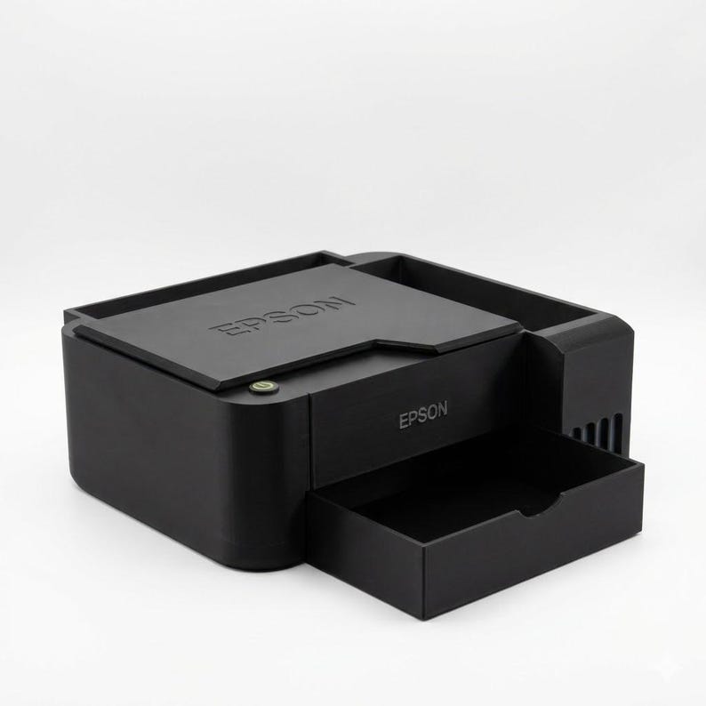 May include: A black Epson printer with a pull-out tray. The printer has the Epson logo on the top and front. The printer is on a white background.