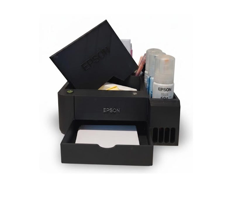 May include: Black Epson printer with a tray, ink bottles, and a top cover. The Epson logo is visible on the printer and cover. The printer is on a white background.