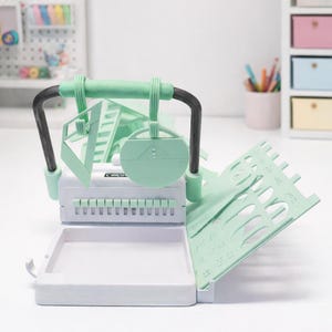 3D model file of a Cinch Binding Machine as a desktop organizer for tools and supplies