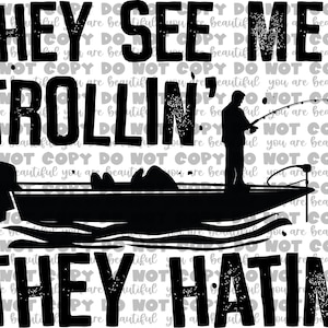 May include: Black and white graphic design featuring a fisherman in a boat with the text "THEY SEE ME TROLLIN' THEY HATIN'". The design includes a boat, a fisherman with a fishing rod, and the phrase in bold letters.