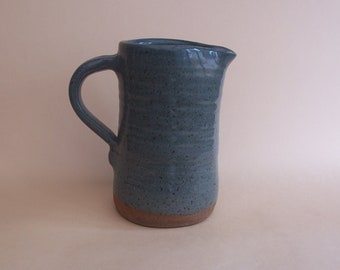 Stoneware jug with turquoise glaze.