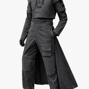 May include: A black outfit consisting of a cropped short-sleeve top with a central square patch, a long-sleeve base layer with ribbed sleeves, and trousers featuring quilted knee panels, a side cargo pocket, and an attached long back panel.