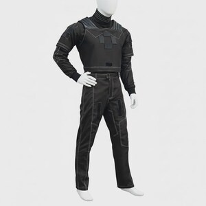 May include: A black tactical-style two-piece outfit consisting of a long-sleeved top and matching trousers. The garment features a high collar, structured chest panel with rectangular accents, and visible white contrast stitching throughout the design.