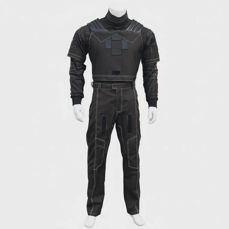 May include: A black tactical-style uniform set consisting of a long-sleeved top with a high collar, shoulder padding, and rectangular patches, paired with matching trousers featuring reinforced stitching, belt loops, and vertical rectangular patches.