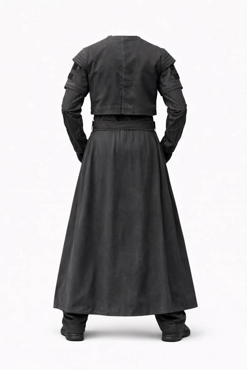 May include: A black long-sleeved jacket and a matching floor-length skirt. The jacket features a cropped cut with ribbed shoulder detailing and vertical pinstripes on the sleeves. The skirt is high-waisted with a wide belt and a flared hem.