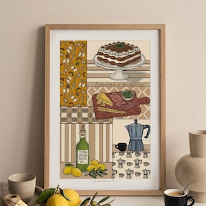 May include: A framed print featuring Italian food illustrations. The artwork includes a layered cake, a charcuterie board with cheese and meats, a bottle of olive oil, lemons, and a coffee maker. The text "ASSAPORA IL MOMENTO" is also visible.