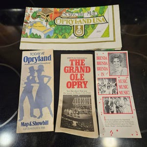 May include: A collection of vintage 1988 Opryland USA paper ephemera including a souvenir map, a Today at Opryland showbill, a Grand Ole Opry ticket information brochure, and a promotional flyer featuring Brenda Lee and Music Music Music.