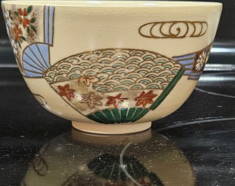 Tazón de té matcha japonés pintado a mano con abanicos y detalles florales dorados, arcilla beige de los años 50.
