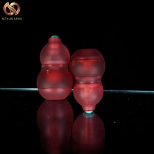 May include: A white ceramic mug with a black handle and the text "But First, Coffee" in a bold, black font. The mug is filled with a dark liquid, likely coffee, and sits on a light-colored surface.