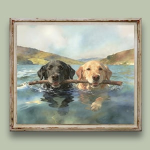 May include: A framed watercolor painting depicting a black Labrador and a golden Labrador swimming side by side in a lake. Both dogs are holding a single wooden stick in their mouths. The background features rolling hills under a soft sky.