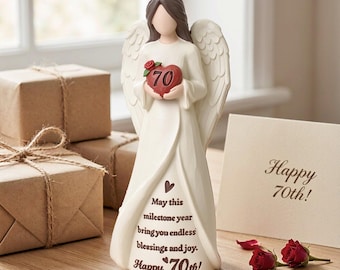 May include: A cream-colored angel figurine with brown hair and feathered wings, holding a red heart marked with the number 70 and a small red rose. The gown features the text: May this milestone year bring you endless blessings and joy. Happy 70th!