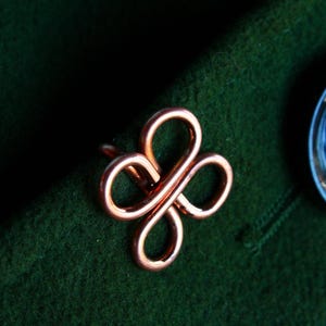 May include: A white ceramic mug with a black handle and the text "But First, Coffee" in a bold, black font. The mug is set against a blurred background, suggesting a cozy setting. The mug appears to be approximately 4 inches tall.