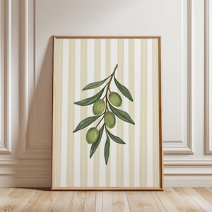 May include: A rectangular wall art print in a thin wooden frame featuring a vertical illustration of an olive branch with green leaves and three green olives centred against a background of alternating cream and light beige vertical stripes.