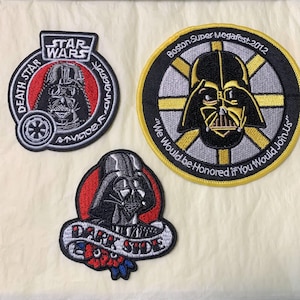 May include: Three embroidered patches featuring Darth Vader from Star Wars. One patch has the text "Death Star" and "Star Wars". Another patch says "Boston Super Megafest 2012" and "We Would be Honored if You Would Join Us". The third patch says "Dark Side".