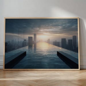 May include: A framed print featuring a cityscape with a rooftop pool. The water reflects the sky and the setting sun, creating a dramatic and serene scene. The buildings are silhouetted against the bright sky.