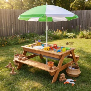 May include: A wooden picnic table with attached benches, topped with a sand-filled play area. A green and white striped umbrella provides shade. The table is surrounded by toys, buckets, and blocks. The text "Wooden Kids House" is visible.