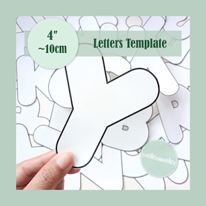 May include: A white letter "Y" template with a black outline, held by a hand. The template is approximately 10cm in size. The image also includes the text "Letters Template".