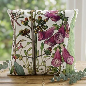 May include: A square throw pillow featuring a botanical illustration on a white background. The design displays tall green stems with clusters of deep purple and magenta foxglove flowers, featuring speckled interiors and green foliage.