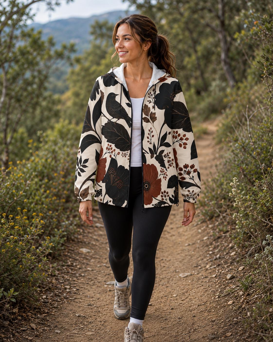 Woman wearing a dark floral bird windbreaker jacket