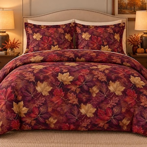 May include: A bedding set featuring a duvet cover and two matching pillow shams decorated with a dense pattern of autumn leaves in shades of deep burgundy, vibrant red, and golden yellow against a dark, moody background.