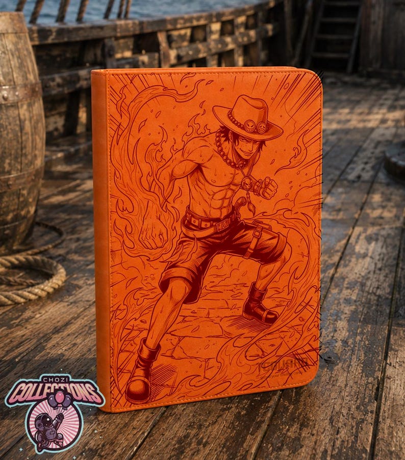 May include: An orange rectangular binder featuring a detailed engraved illustration of a shirtless character wearing a hat, shorts, and boots, surrounded by flames. The cover displays a dynamic action pose with lines radiating outward from the center.