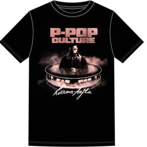May include: Black t-shirt with a graphic featuring the text "P-POP CULTURE" in a rose gold color. The graphic includes an image of a person and the name "Karan Aujla" in a script font.