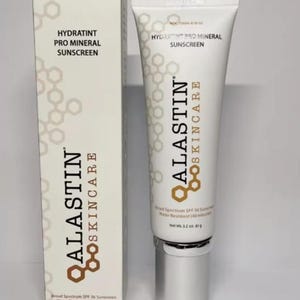 May include: White tube and box of Alastin Skincare Hydratint Pro Mineral Sunscreen. The tube and box feature the brand name and product information. The sunscreen is broad spectrum SPF 36 and water resistant. The net weight is 3.2 oz (91 g).