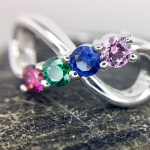 Four birthstones set in the center of an infinity ring, sterling silver