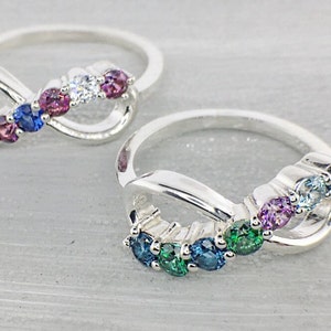 Multiple birthstone rings with an infinity design, set with family birthstone colors