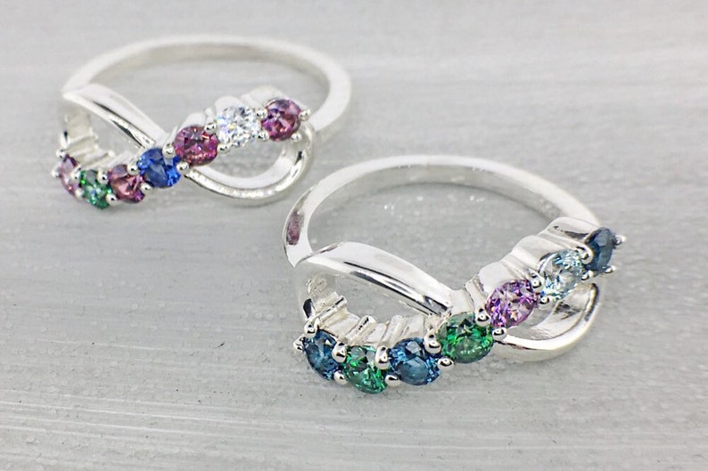 Multiple birthstone rings with an infinity design, set with family birthstone colors