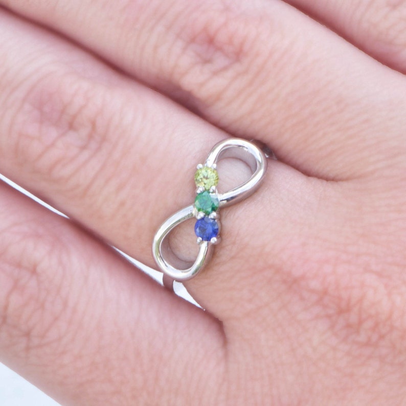 Mothers Birthstone Ring with three birthstones set in the center of an infinity design
