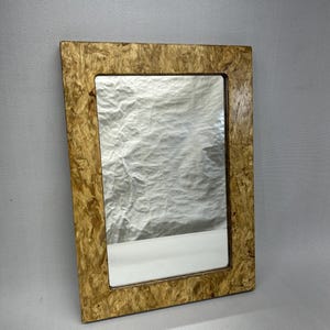 Handmade mirror, made from pre-consumer recycled oriented strand board (OSB).