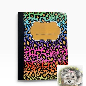 May include: A notebook featuring a vibrant rainbow leopard print pattern with a black spine and a central tan scalloped label with a dotted line. A small square inset shows a fluffy dog with a pink bow and the text Josie Leigh Creations.