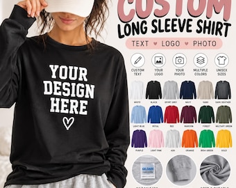 May include: A black long-sleeve shirt with white text that reads YOUR DESIGN HERE and a heart icon. The image displays a color chart with twenty-one shirt color options, icons for customization, and close-ups of the Gildan 5400 fabric and cuffs.