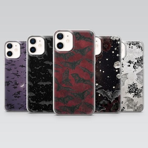 May include: Five phone cases with gothic-themed designs. The cases display bat patterns, floral motifs, and celestial imagery in black, red, and purple hues. These cases are designed to fit a smartphone.
