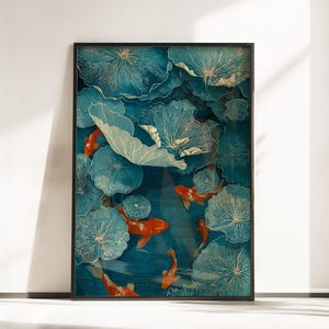 May include: Framed art print depicting orange koi carp swimming amongst large, stylized blue lily pads. The artwork has a textured appearance and is set against a dark teal background.
