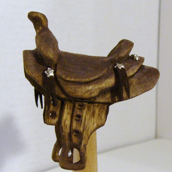 Hand carved saddle ornament
