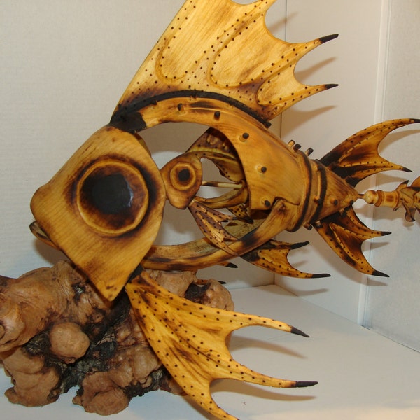 Mother of all fish. Hand carved Mechanical fish with propeller that turns by hand. Carving has saw blade teeth.