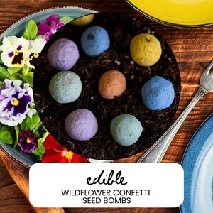 May include: A close-up shot of colorful seed bombs arranged on a bed of soil. The seed bombs are in various pastel colors, including blue, purple, and green. The image also includes a plate of flowers and the text "edible WILDFLOWER CONFETTI SEED BOMBS".