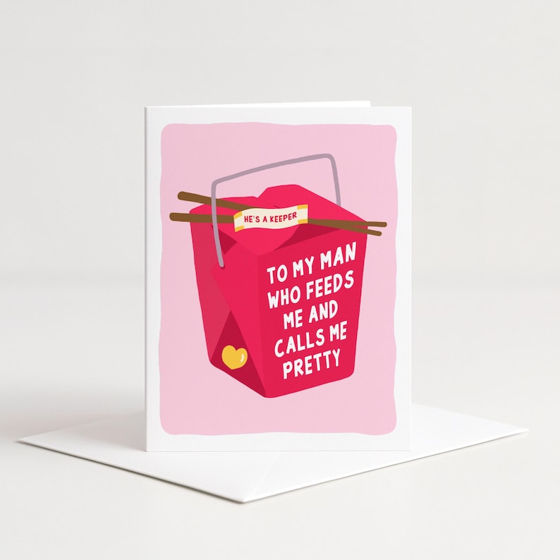 May include: A greeting card with a red takeout container design. The card reads "TO MY MAN WHO FEEDS ME AND CALLS ME PRETTY" and includes the words "HE'S A KEEPER." Chopsticks and a yellow heart are also featured.