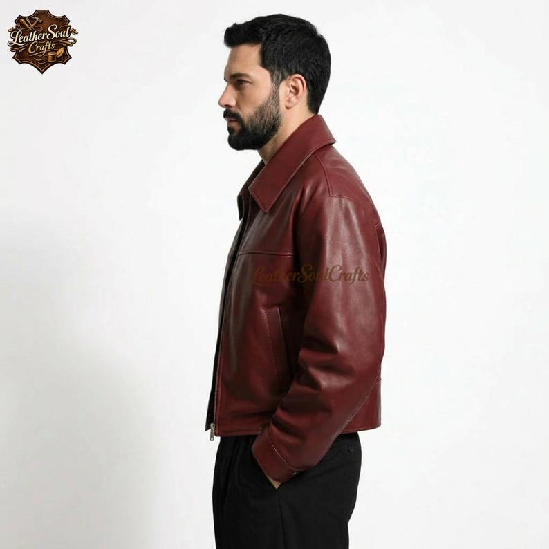 May include: A burgundy leather jacket with a collared neckline and a front zipper closure. The jacket has a classic design with a tailored fit. The Leather Soul Crafts logo is visible on the upper left corner of the image.