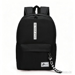 May include: A black backpack featuring a vertical white rectangular patch with the text BE YOUR STYLE. It includes a front zippered pocket with a small rectangular logo patch reading PAK.UP and a black and white branded fabric zipper pull.