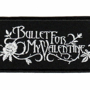 May include: A rectangular black embroidered patch featuring the white text Bullet For My Valentine in a stylized font. The design includes intricate white floral and vine embroidery surrounding the lettering, with a thick black stitched border.